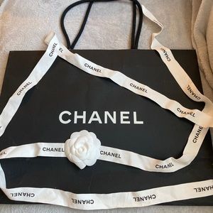 Chanel shopping paper bag with ribbon and flower